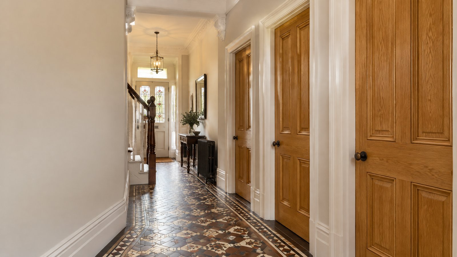 Hallway with matching oak four-panel internal doors in a Sheffield period home